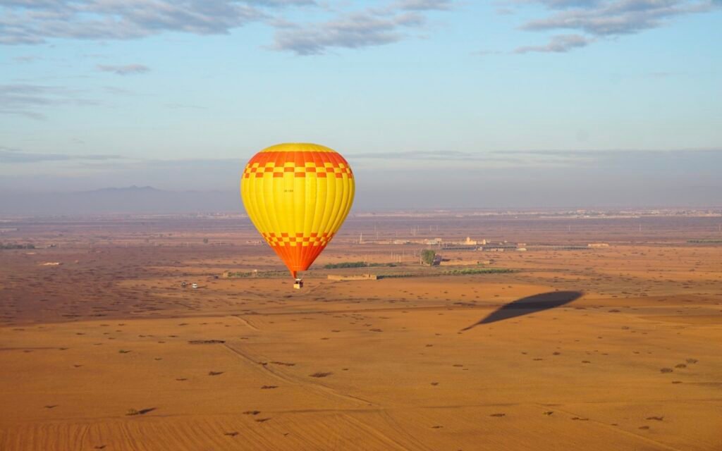 Hot air balloon over the plain near Marrakech at sunrise